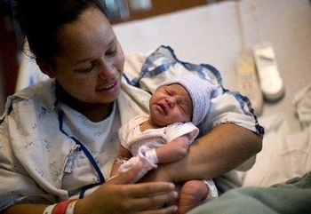 Dominique Trevino, 18, holds her daughter, Sariah, on Wednesday at Denver Health Medical Center. She expects to be discharged today, and will not go home to east Denver by bus, which she was riding when she went into labor Tuesday morning.