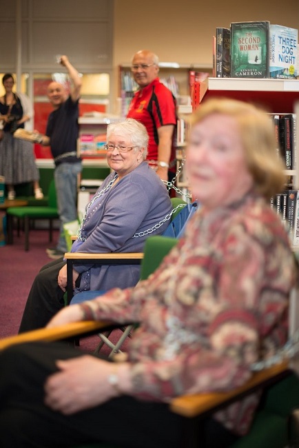 Angry protesters chain themselves to bookshelves in last ditch attempt to save library Angry protesters chain themselves to bookshelves in last ditch attempt to save library