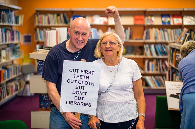 Angry protesters chain themselves to bookshelves in last ditch attempt to save library Angry protesters chain themselves to bookshelves in last ditch attempt to save library